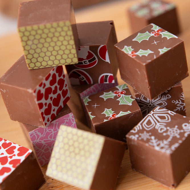 Stack of patterned chocolate cubes on a wooden surface
