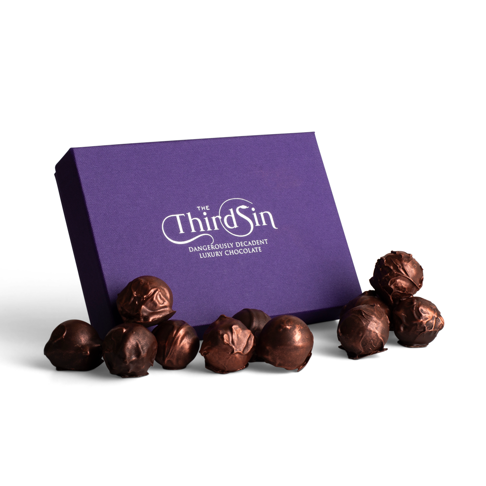Purple box with 'The Third Sin' branding and chocolate truffles on a white background