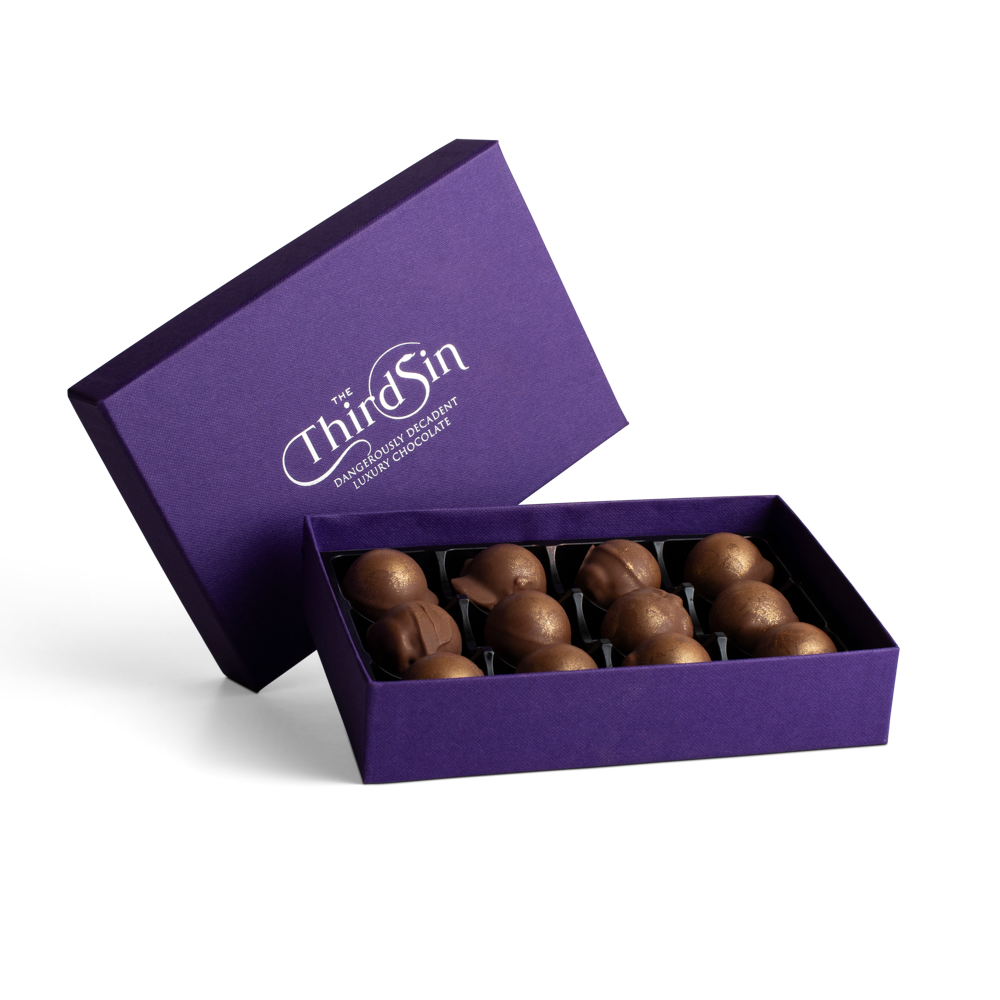 Open purple box of chocolates with 'The Third Sin' branding on a white background