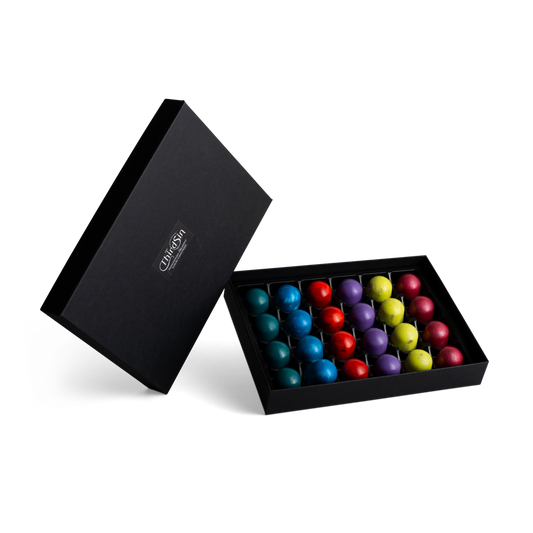 Black box with colorful chocolates on a white background