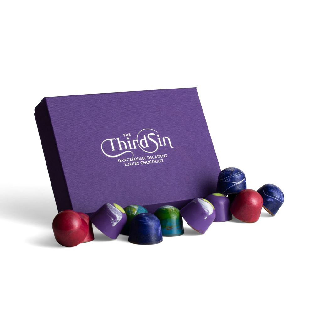 Purple box of 'The Third Sin' chocolates on a white background
